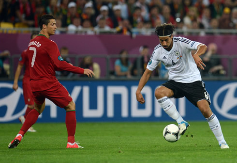 Cristiano Ronaldo looking at Sami Khedira controlling the ball, in Portugal vs Germany for the EURO 2012