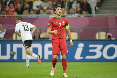 Cristiano Ronaldo looking to the sky, while Thomas Muller runs behind him, in Germany 1-0 Portugal for the EURO 2012
