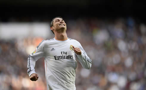 Cristiano Ronaldo drops his head back as he continues running