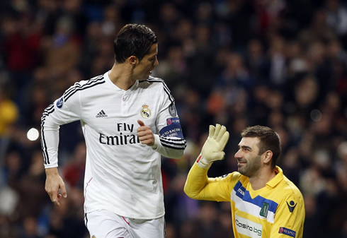 Cristiano Ronaldo looking at the goalkeeper he just scored against, who smiles at him