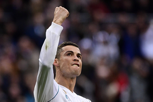 Cristiano Ronaldo holds his his hand high in the air after he leads Real Madrid to a 5-0 win over Sevilla