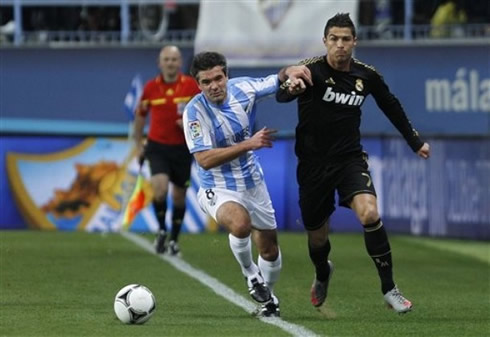 Cristiano Ronaldo being pushed by the French player, Toulalan, when sprinting side by him