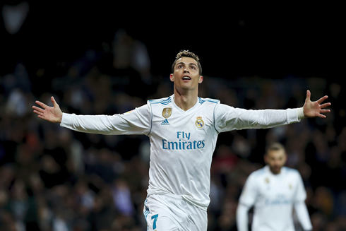 Cristiano Ronaldo stretching and opening his arms towards the crowd at the Bernabéu