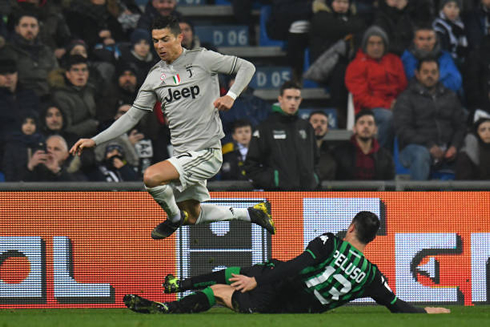 Cristiano Ronaldo jumps over the legs of an opponent, in Juventus 3-0 away win against Sassuolo