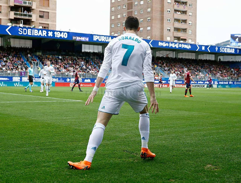 Cristiano Ronaldo turns his back to the stands and waits for his teammates to join him near the corner flag