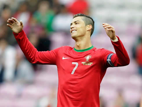 Cristiano Ronaldo smiles and puts his arms in the air, in a reaction to a play during Croatia 0-1 Portugal, in 2013