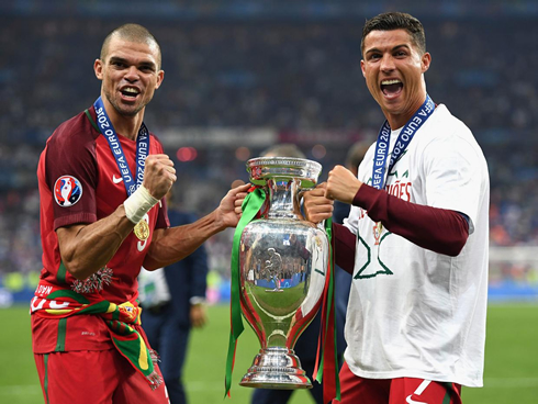 Pepe and Cristiano Ronaldo holding the EURO 2016 trophy