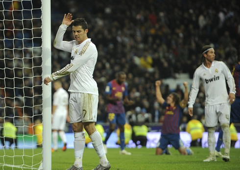 Cristiano Ronaldo and Sergio Ramos looking frustrated while Barcelona players celebrate in the Clasico
