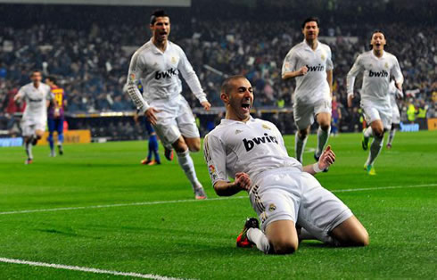 Karim Benzema celebrates his goal against Barcelona sliding on his knees, while Cristiano Ronaldo, Xabi Alonso and Mesut Ozil approach him from behind