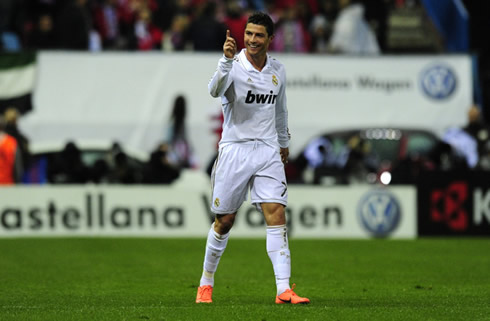 Cristiano Ronaldo smiling and pointing his finger at someone in Real Madrid bench