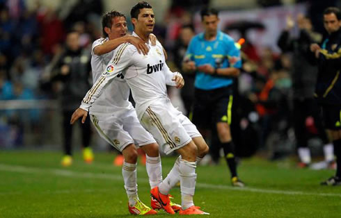 Fábio Coentrão preparing to climb to Cristiano Ronaldo's back, as Real Madrid gets the opener against Atletico Madrid, in 2012