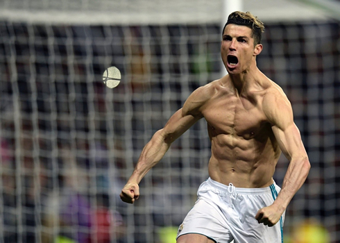 Cristiano Ronaldo showing off his abs and upper body muscles after scoring a goal for Real Madrid in the Champions League