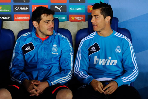 Cristiano Ronaldo and Iker Casillas chatting while being seated on Real Madrid's bench, in 2013