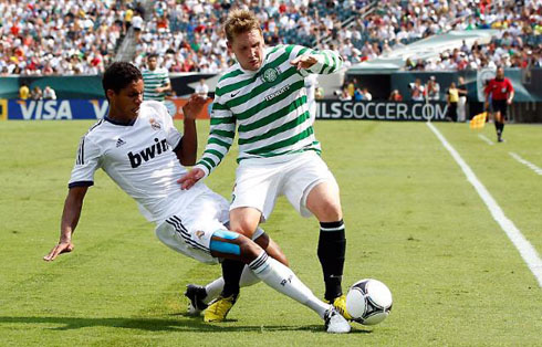 Varane making a sliding tackle during a soccer game between Real Madrid and Celtic, in 2012-2013, at the United States tour
