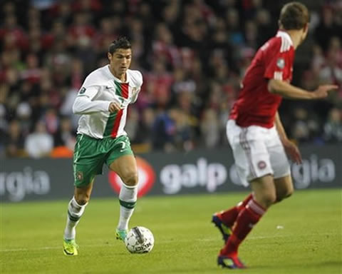 Cristiano Ronaldo preparing to take on a Danish defender in Euro 2012 Qualifiers
