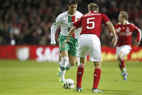 Cristiano Ronaldo running with the ball and about to dribble a defender in 2011-2012