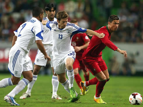 Cristiano Ronaldo battling for the ball in a tie between Portugal and Israel, for the 2014 FIFA WC qualifiers