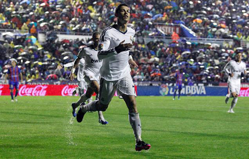 Cristiano Ronaldo running in a wet pitch, as he puts Real Madrid one goal up against Levante, in the Spanish League 2012-2013