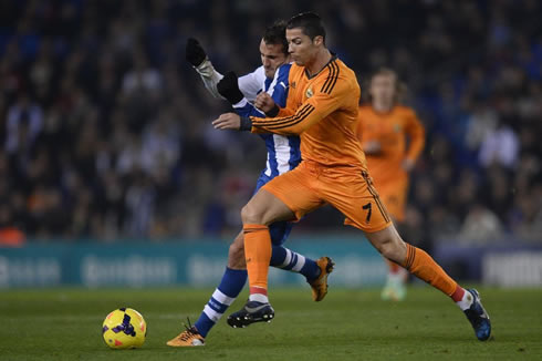 Cristiano Ronaldo holding his balance as gets pushed by a defender, in Espanyol vs Real Madrid