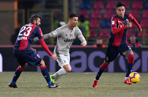 Cristiano Ronaldo trying to escape two defenders by using his speed
