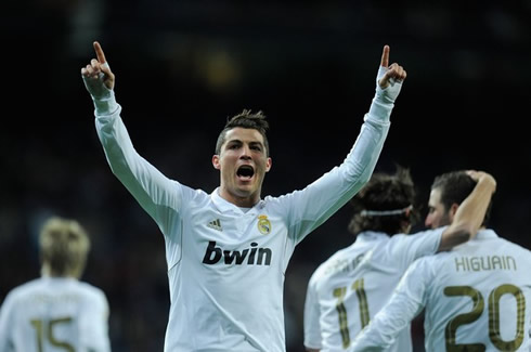 Cristiano Ronaldo smiles to the crowd and points his two fingers up, in Real Madrid vs Levante in 2012