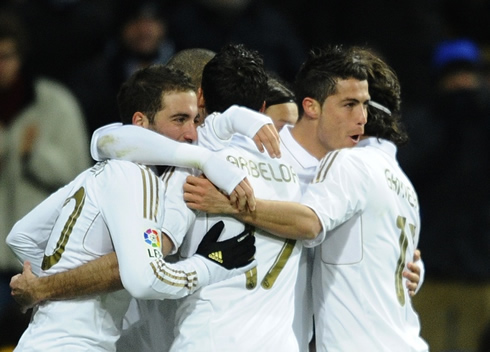 Cristiano Ronaldo in a Real Madrid group hug, with Higuaín, Arbeloa, Granero, Pepe and Ozil