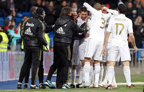 Cristiano Ronaldo gets congratulated by Real Madrid players and staff members after scoring his hat-trick in the Santiago Bernabéu