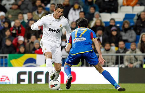 Cristiano Ronaldo puts the ball under his boot, as he tries to dribble a defender in La Liga 2012