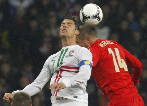 Cristiano Ronaldo jumping to head the ball in the air, with a Russian defender in Russia 1-0 Portugal, in 2012-2013