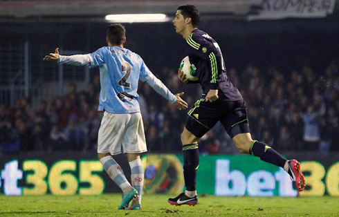 Cristiano Ronaldo running back with the ball pressed against his chest, as Real Madrid attempts a remontada against Celta de Vigo in 2012-2013