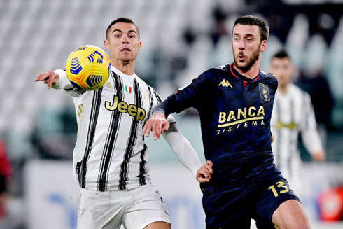 Cristiano Ronaldo battling for possession with a Genoa player