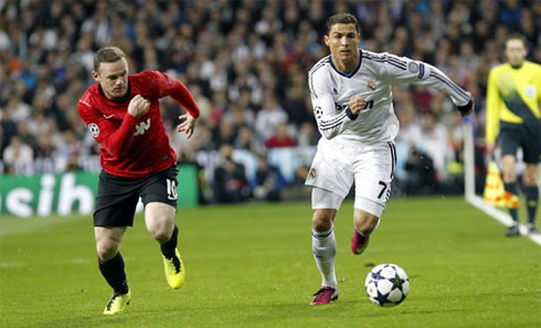 Cristiano Ronaldo running side by side with Wayne Rooney, in Real Madrid vs Manchester United for the Champions League first leg, in 2013