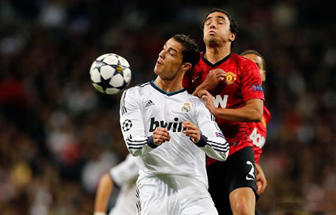 Cristiano Ronaldo jumping and hitting the ball with his shoulder, in Real Madrid vs Man Utd, for the UEFA Champions League first leg in 2013