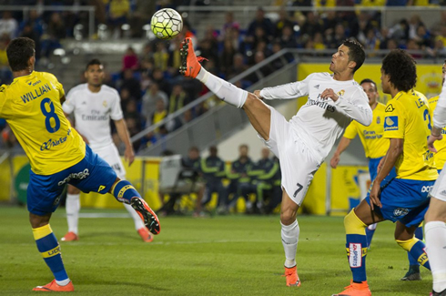 Cristiano Ronaldo raises high his right foot to make contact with the ball