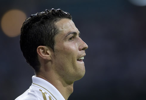Cristiano Ronaldo biting his tongue and looking far away, in a game for Real Madrid in La Liga 2012