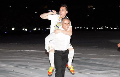 Jose Callejón jumping to José Mourinho back, in Real Madrid's La Liga celebrations party at the Santiago Bernabéu, in 2012