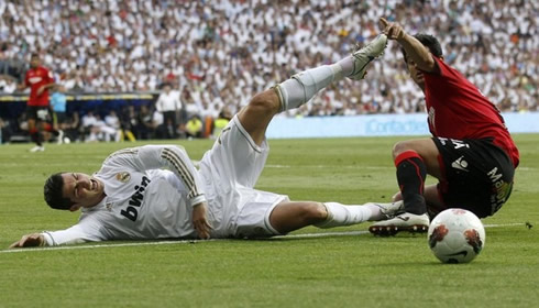 Cristiano Ronaldo goes to the ground after being tackled by a Mallorca defender in La Liga 2012