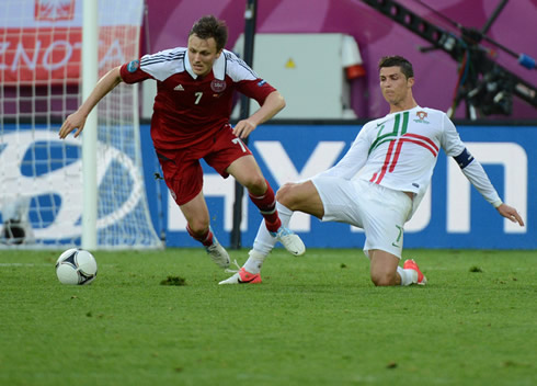 Cristiano Ronaldo fouling a Danish player and receiving a yellow card for it, in the EURO 2012