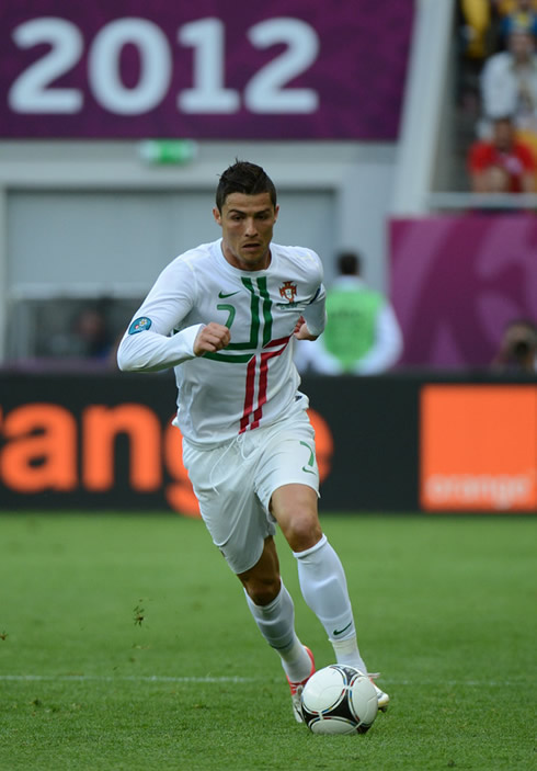 Cristiano Ronaldo running with the ball close to his feet, in Portugal vs Denmark for the EURO 2012