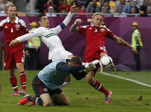Cristiano Ronaldo trying to stretch his right leg and reach the ball, in a challenge during the Portugal 3-2 Denmark, for the EURO 2012