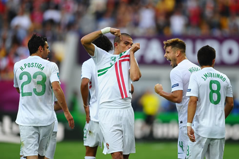 Pepe, Hélder Postiga, Miguel Veloso and João Moutinho walking back to their side of the pitch, after celebrating Portugal goal against Denmark in the EURO 2012