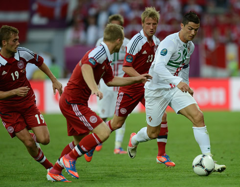 Cristiano Ronaldo running away from three Danish defenders in the EURO 2012