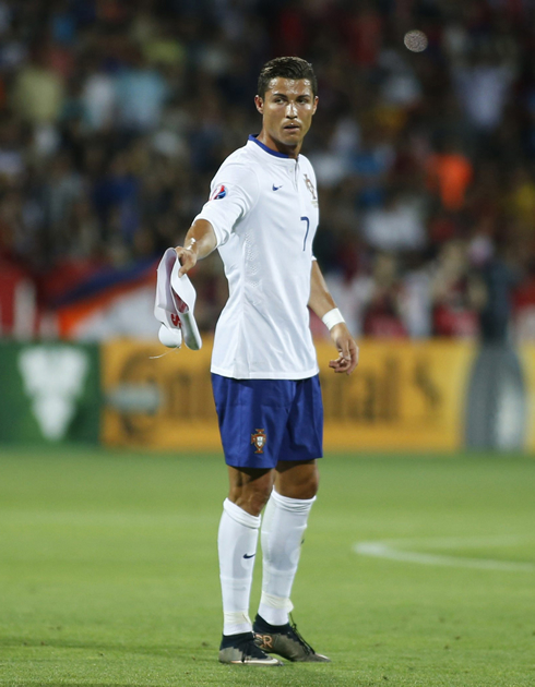 Cristiano Ronaldo hands out the Armenia mini flag to someone on the Portuguese bench