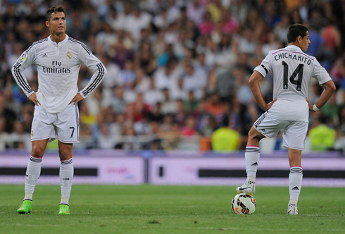 Cristiano Ronaldo looking upset as he stands next to Real Madrid new signing, Chicharito