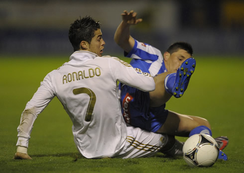 Cristiano Ronaldo gets on the bottom of a defender, after both players attempted to slide to the ball