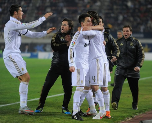 Callejón celebrating his goal for Real Madrid with Sergio Ramos and Rui Faria from the coaching staff, while Cristiano Ronaldo joins them smiling