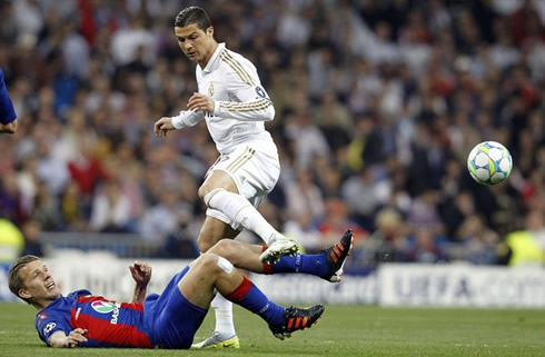 Cristiano Ronaldo loses the ball after a strong tackle from a defender