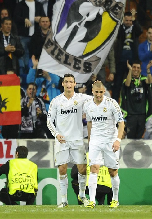 Cristiano Ronaldo and Benzema celebrating a goal with Real Madrid Ultra sur fans applauding behind them