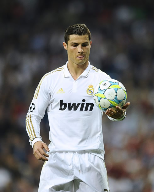 Cristiano Ronaldo holding the new UEFA Champions League ball with only his left hand