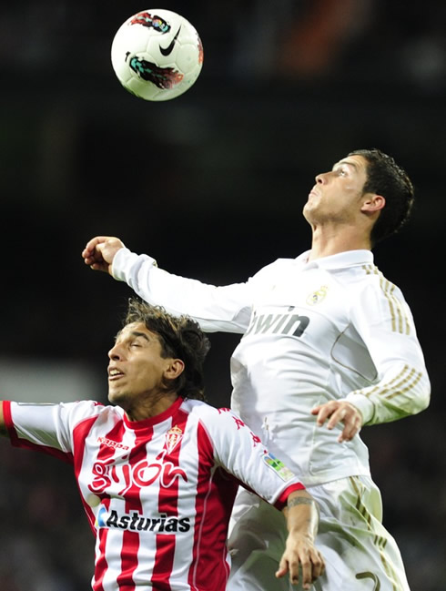 Cristiano Ronaldo raising above a defender in Real Madrid vs Sporting Gijon, in 2012
